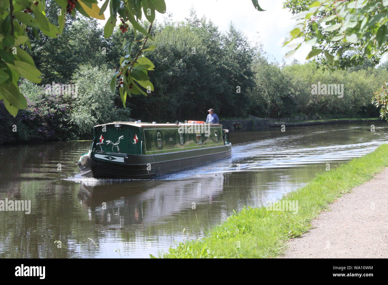 Narrow boat cruising along the Aire and Calder Navigation, a canal in Knottingley West Yorkshire in Britain,UK Stock Photo