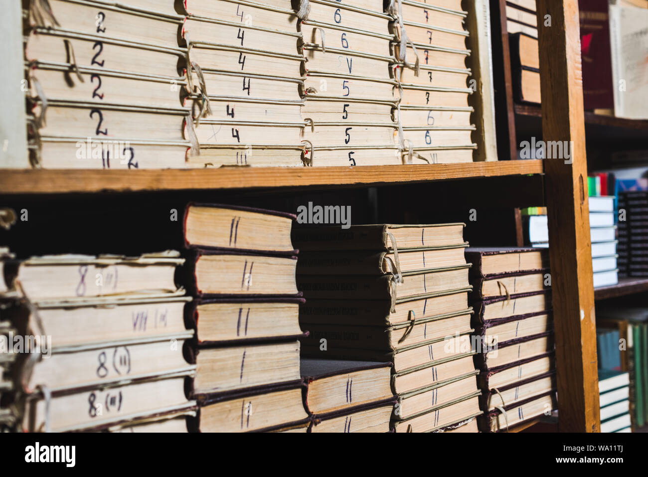 vintage and retro books on wooden shelves in library Stock Photo - Alamy