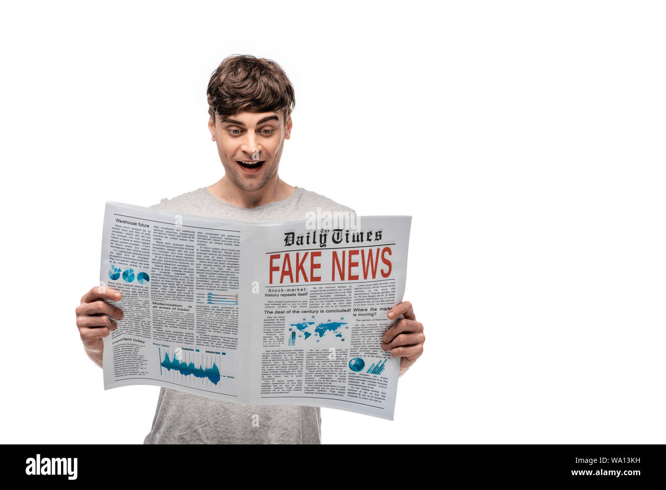 cheerful handsome man reading newspaper with fake news isolated on ...