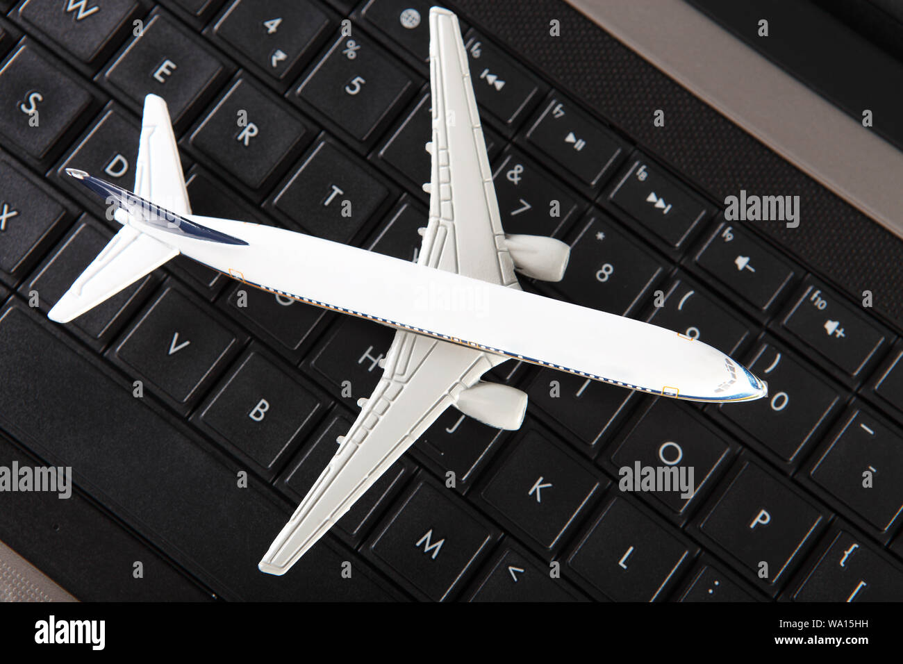 Model airplane on laptop keyboard Stock Photo Alamy