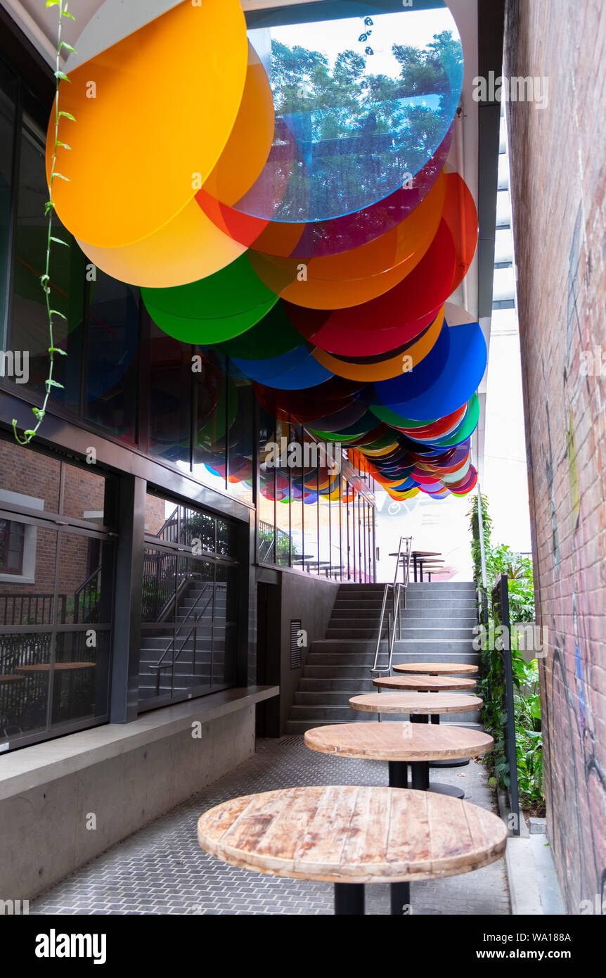 Colourful acrylic discs designed by Nike Savvas suspended above laneway in  Brisbane, Australia Stock Photo - Alamy
