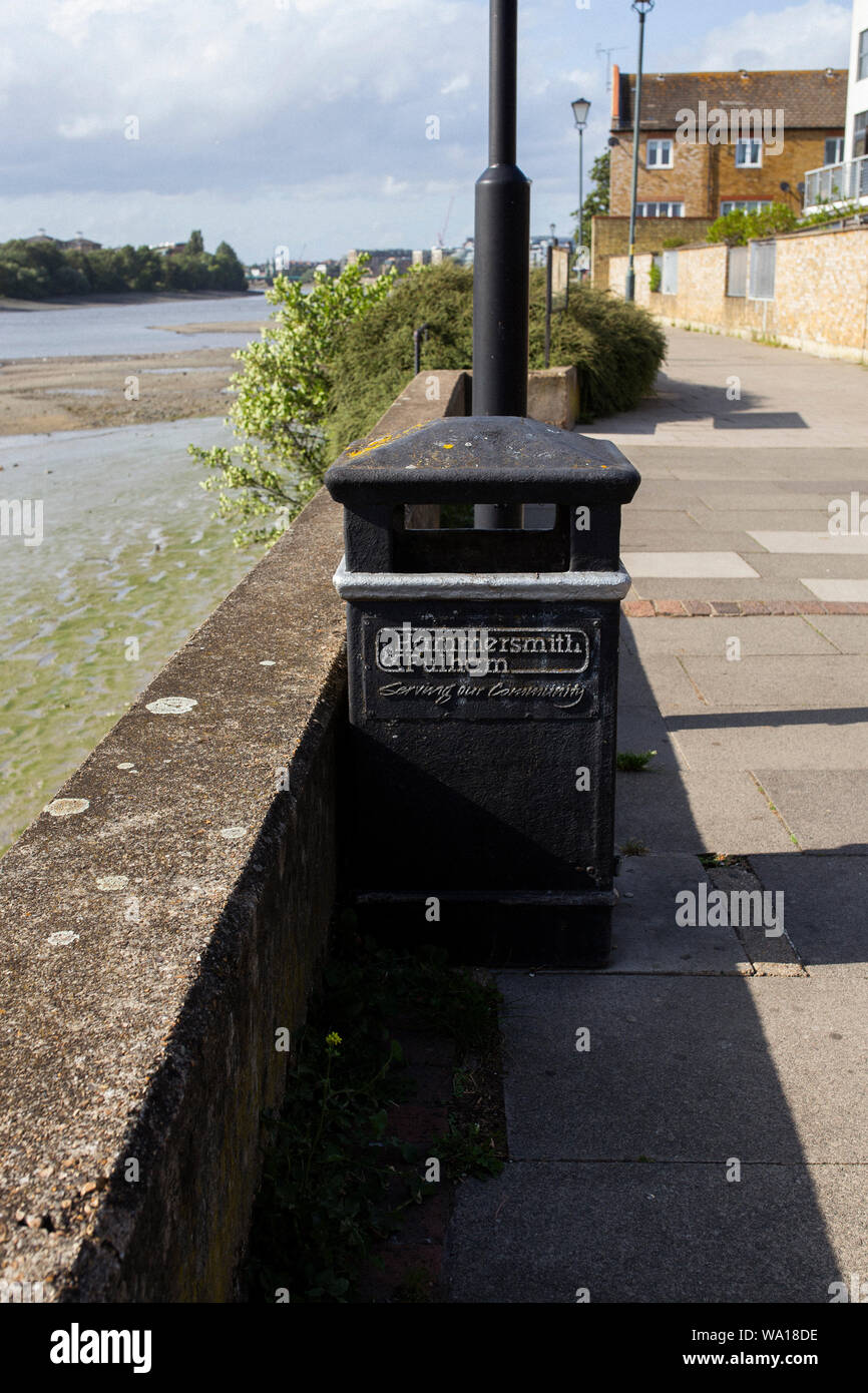 Hammersmith & Fulham council-branded bin by the River Thames in Fulham, London Stock Photo