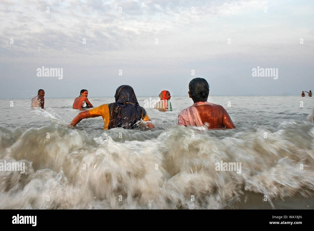 People from the Hindu community bathe at the Bay of Bengal during the Rash Mela at Dublarchar in the Eastern Division of Sundarbans forest.Khulna. Stock Photo