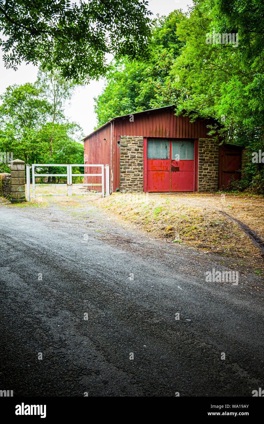 Red doors on an old industrial workshop building or garage, near Consett, County Durham, England, UK Stock Photo