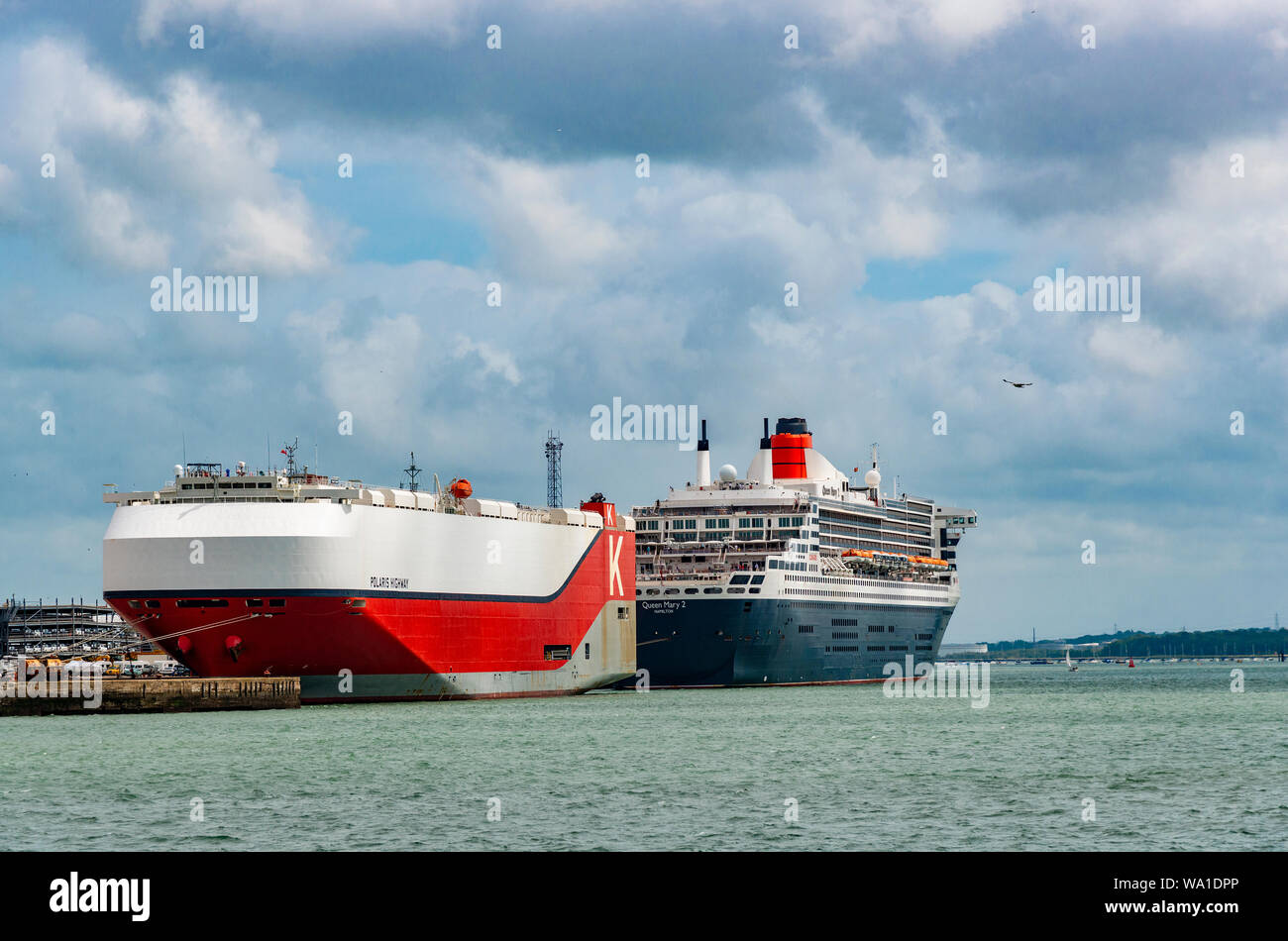 A 'K' Line vehicle carrier docked with Queen Mary 2 at Southampton Docks, Southampton Water, Hampshire, England, UK Stock Photo