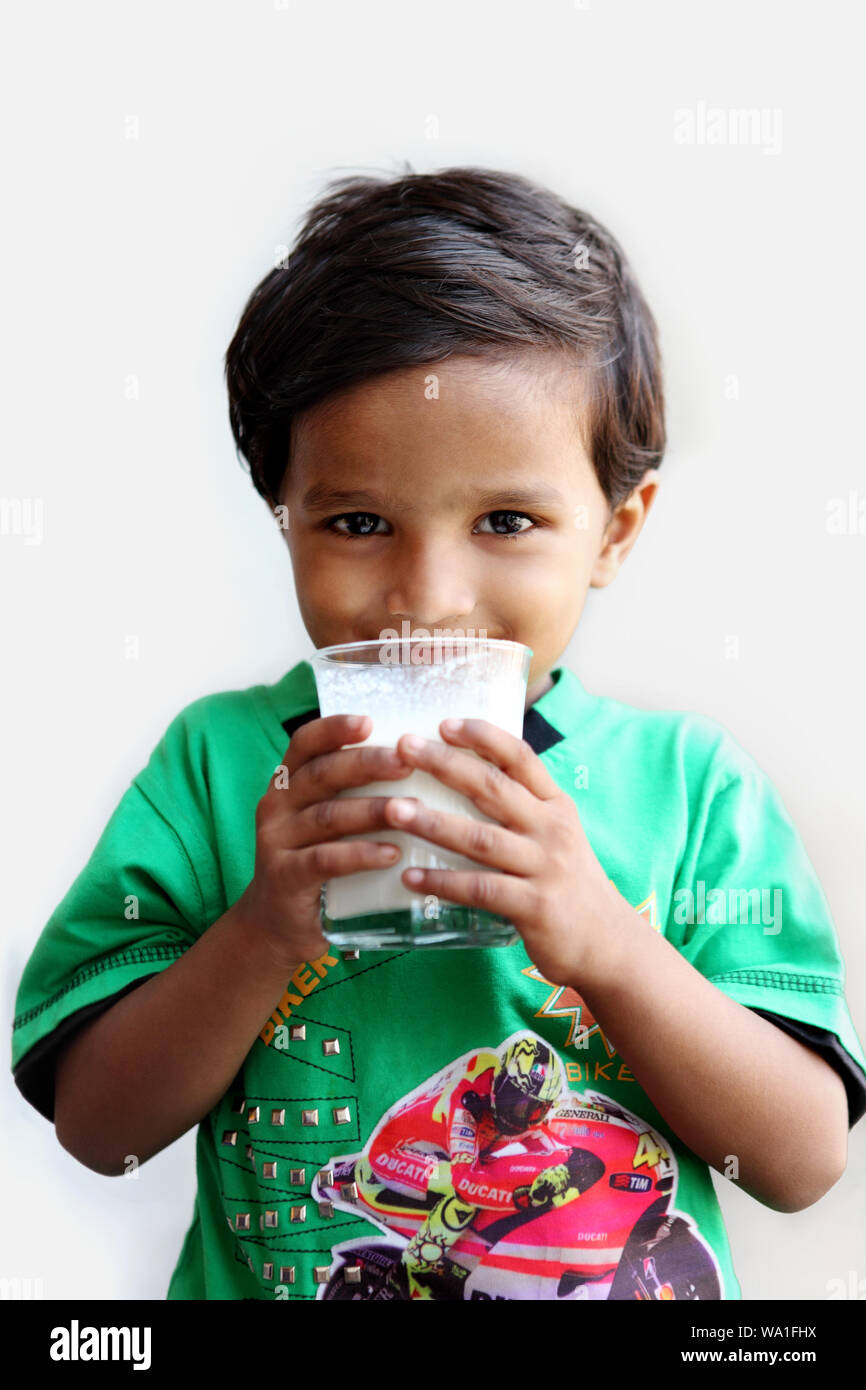 Boy drinking glass of milk Stock Photo Alamy