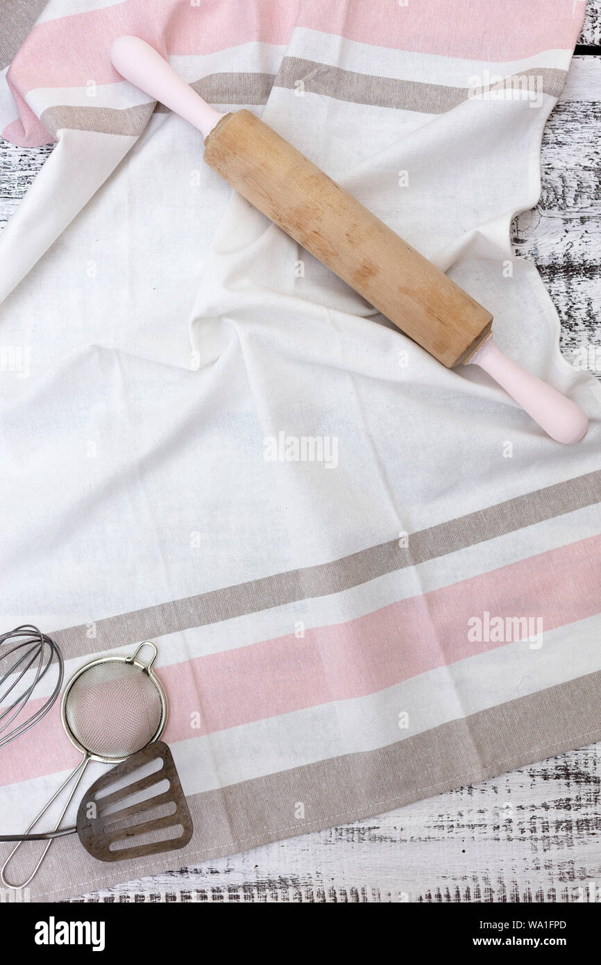 Old vintage kitchen utensils, cotton dishcloth on old white wooden background. Selective focus. Stock Photo