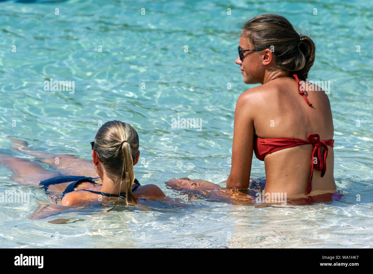 Young women cool off in shallow water at beach Ko Nang Yuan Thailand Stock Photo