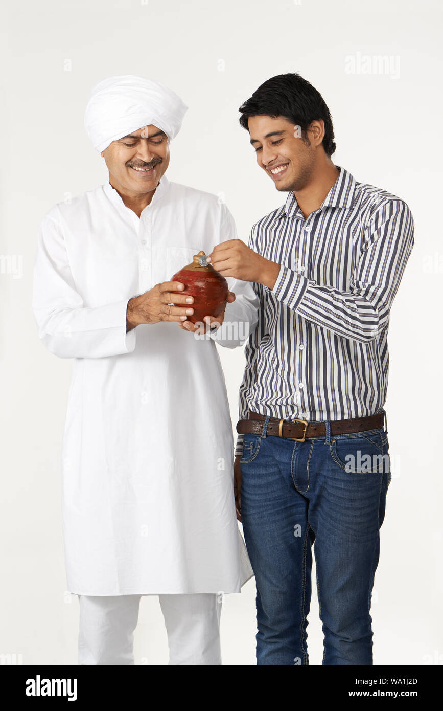 Father and son putting coin piggy bank hi-res stock photography and ...