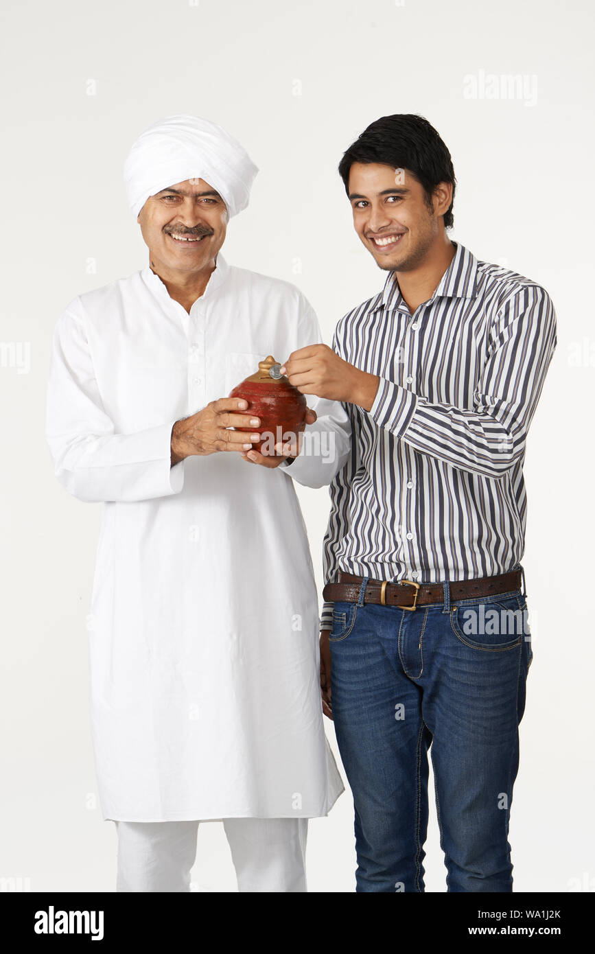 Father and son putting coin piggy bank hi-res stock photography and ...