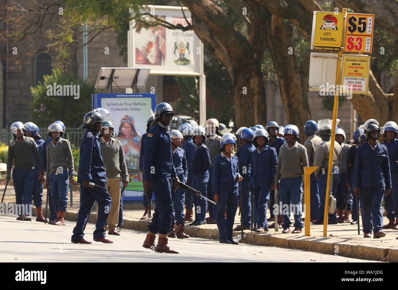 Harare, Zimbabwe. 16th Aug, 2019. Police officers stand guard in Harare, Zimbabwe, on Aug. 16, 2019. Shops, banks and retail outlets in Zimbabwe's capital Harare were closed on Friday after the High Court banned a planned demonstration by the opposition MDC Alliance. Heavily armed police officers patrolled the central business district while some were stationed at strategic areas in the city center, including at Africa Unity Square where protesters were due to congregate. Credit: Shaun Jusa/Xinhua Credit: Xinhua/Alamy Live News Stock Photo