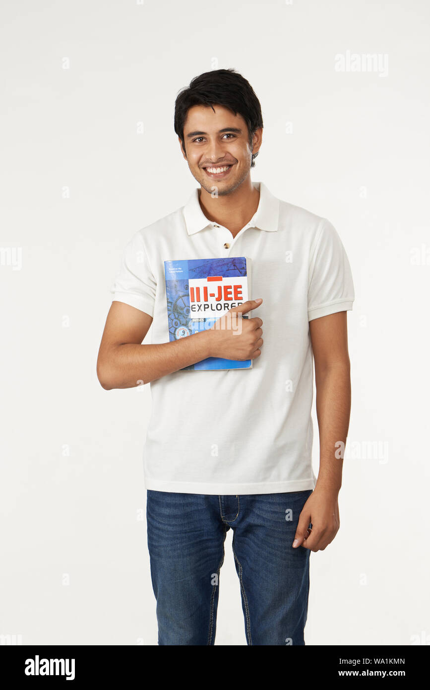 College student smiling with holding a book Stock Photo - Alamy