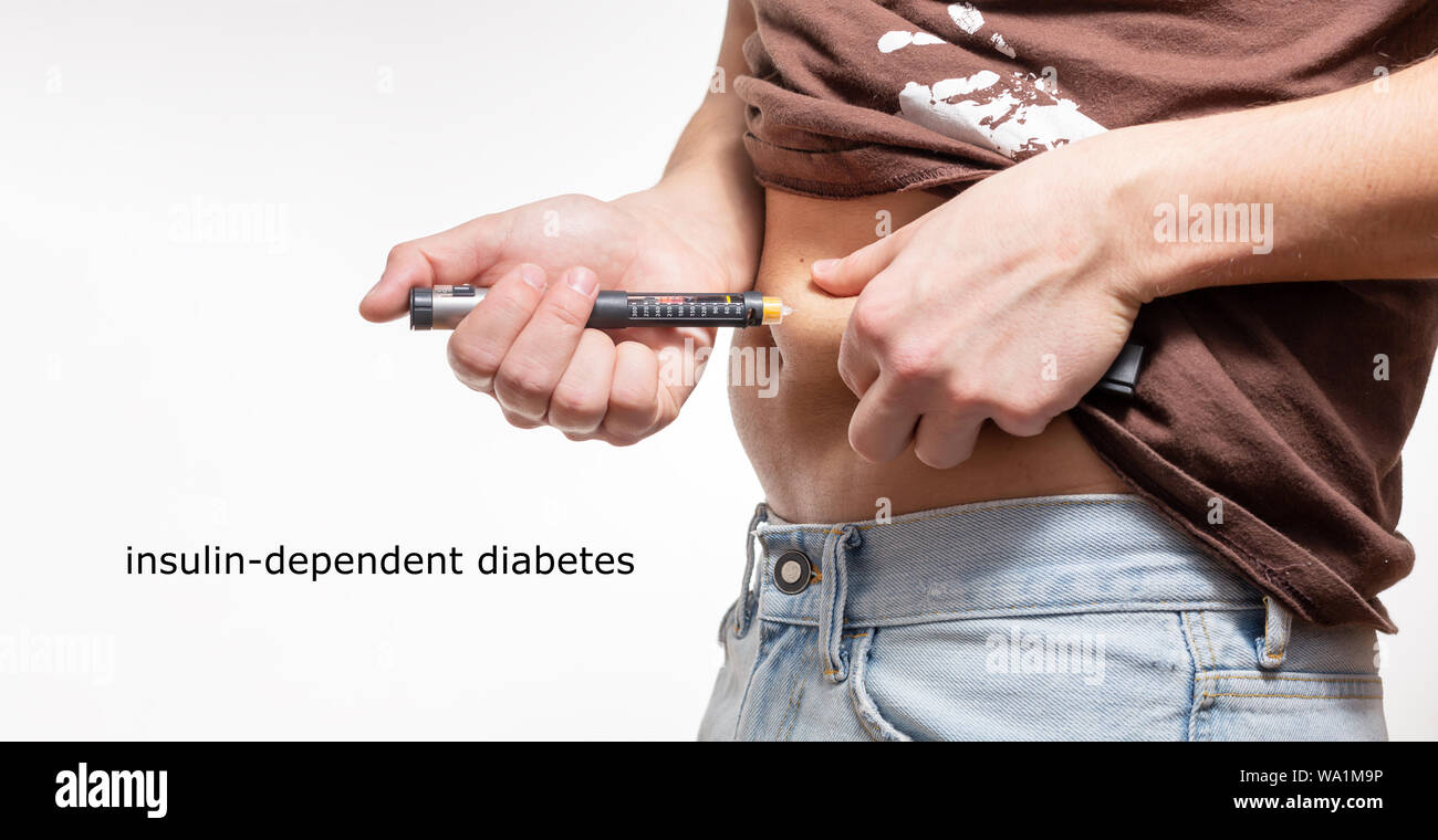 Male Injecting insulin in stomach (abdomen) on isolated white background Stock Photo