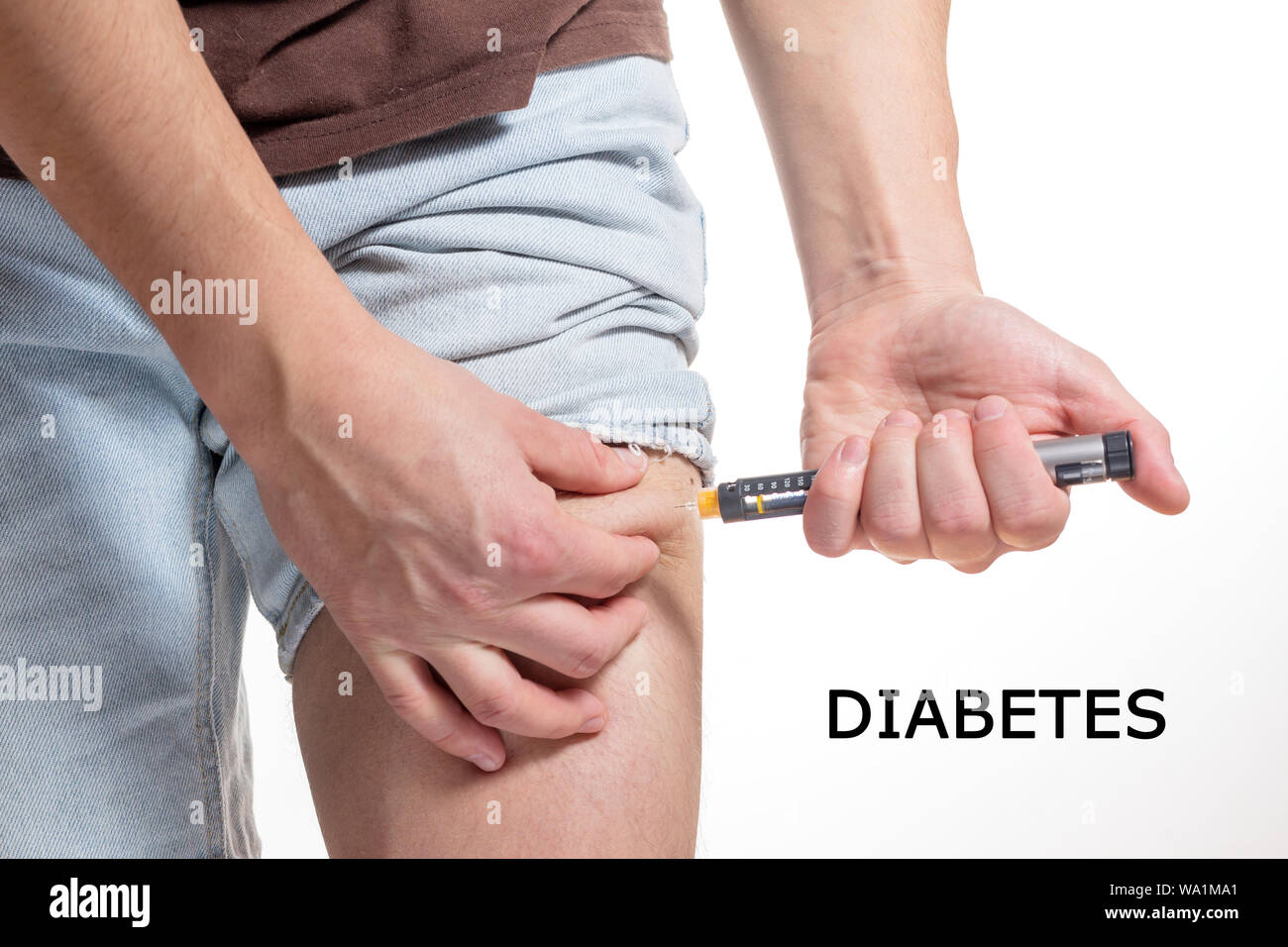 Male Injecting insulin in leg fold on isolated white background Stock Photo