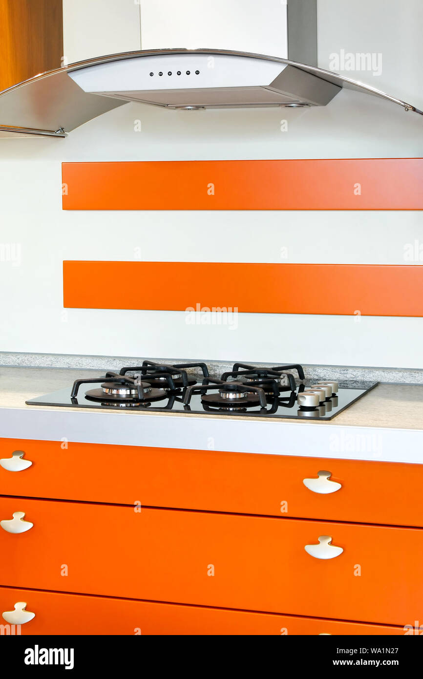 Orange style kitchen with gas burners stove Stock Photo Alamy