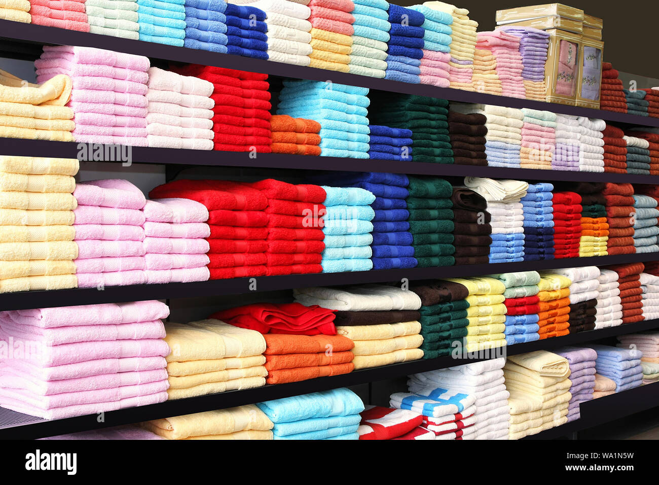 Pile of colorful towels at long racks Stock Photo - Alamy