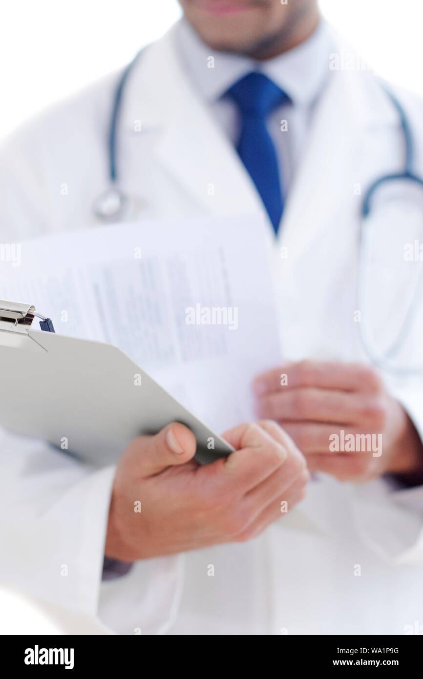 Doctor holding clipboard, close-up. Stock Photo
