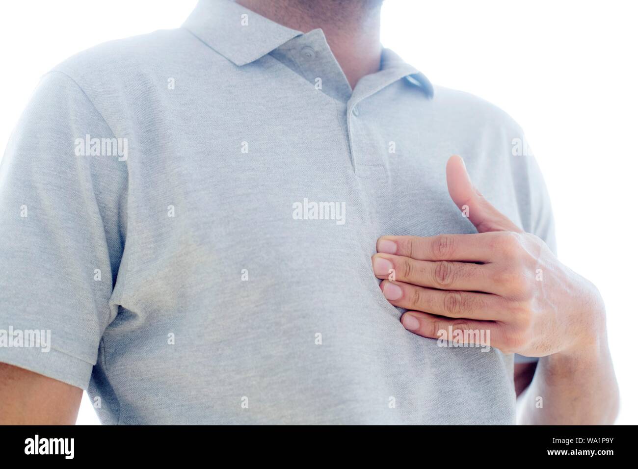 Man touching his chest in pain. Stock Photo