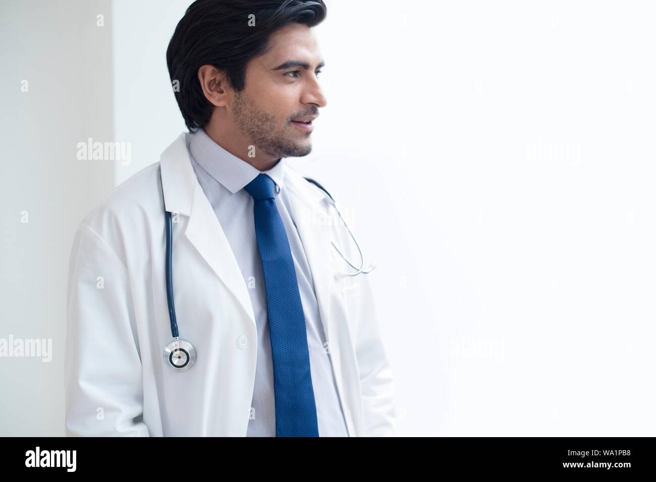Doctor with stethoscope, looking away. Stock Photo