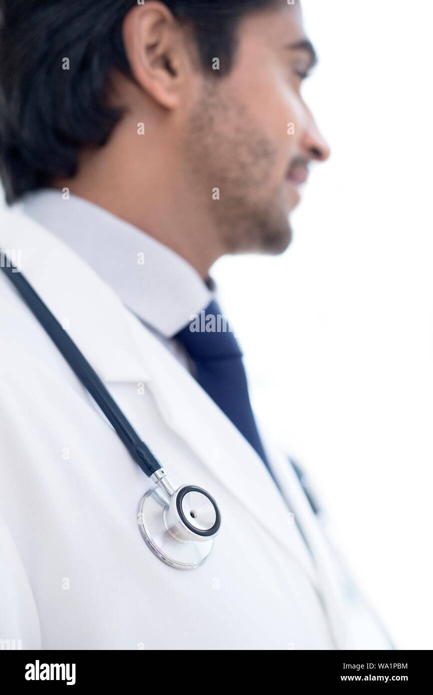 Doctor with stethoscope, looking away. Stock Photo