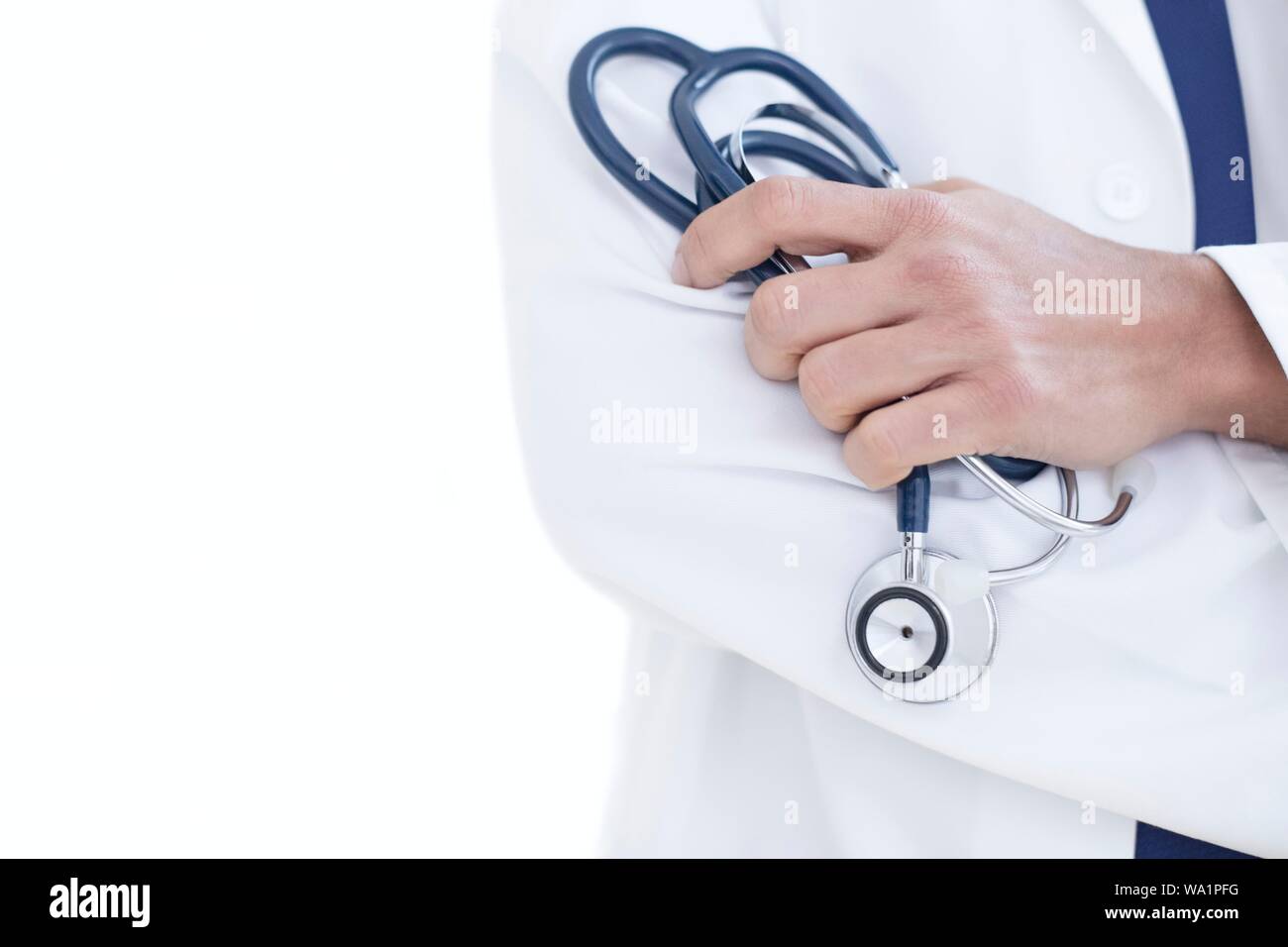 Doctor holding stethoscope, close-up. Stock Photo