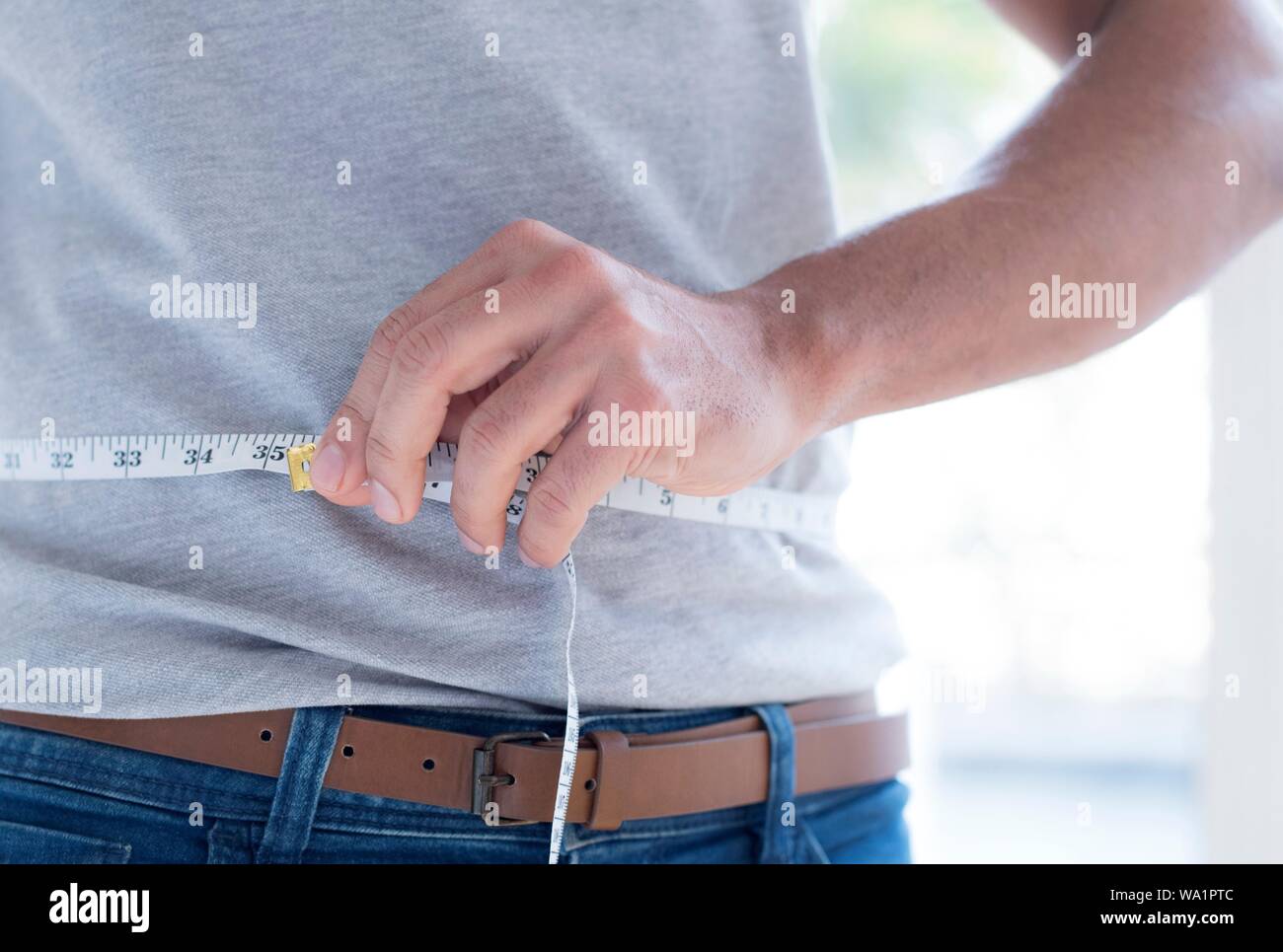 Man measuring waist. Stock Photo
