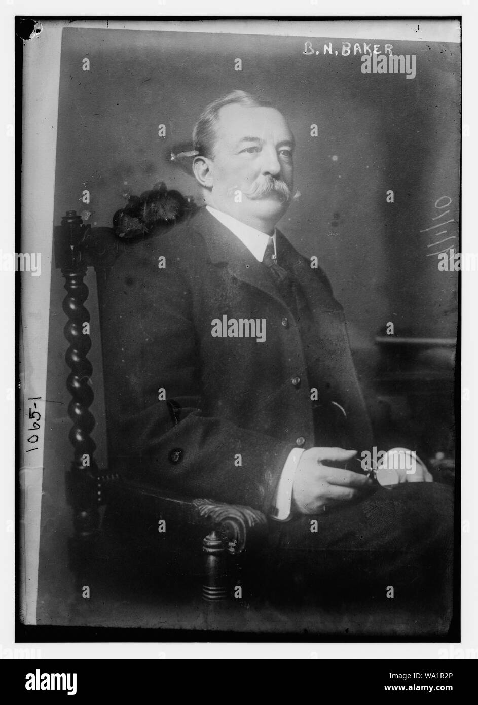 B.N. Baker seated holding glasses Stock Photo