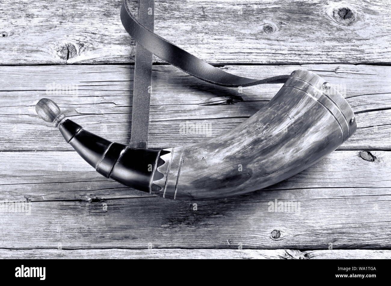 Antique gunpowder horn was carried by men in the 18th and 19th century in black and white. Stock Photo