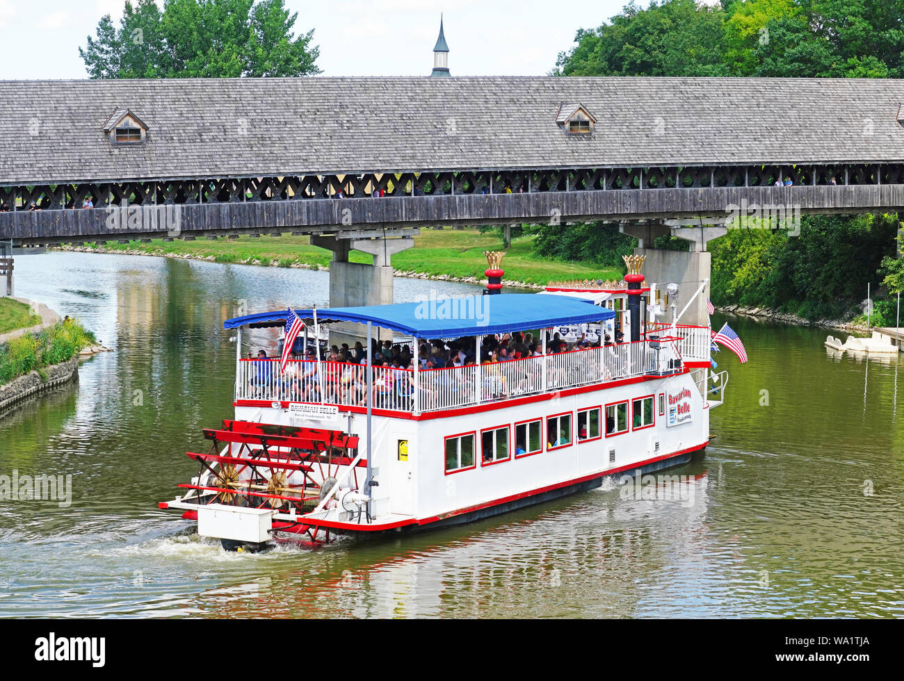 Bavarian Belle Riverboat on sightseeing cruise of Cass River at the Frankenmuth wooden covered bridge. Stock Photo