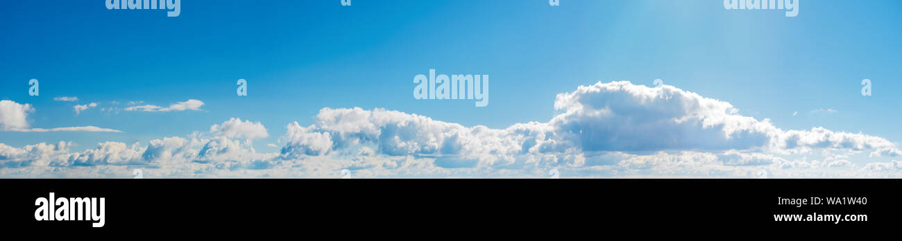 amazing cloud formations on a bright blue sky. beautiful side lit cloudscape panorama in springtime Stock Photo