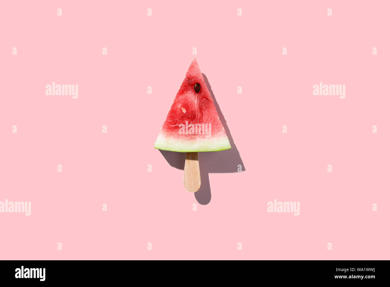 Watermelon slice popsicles on a pink color background Stock Photo