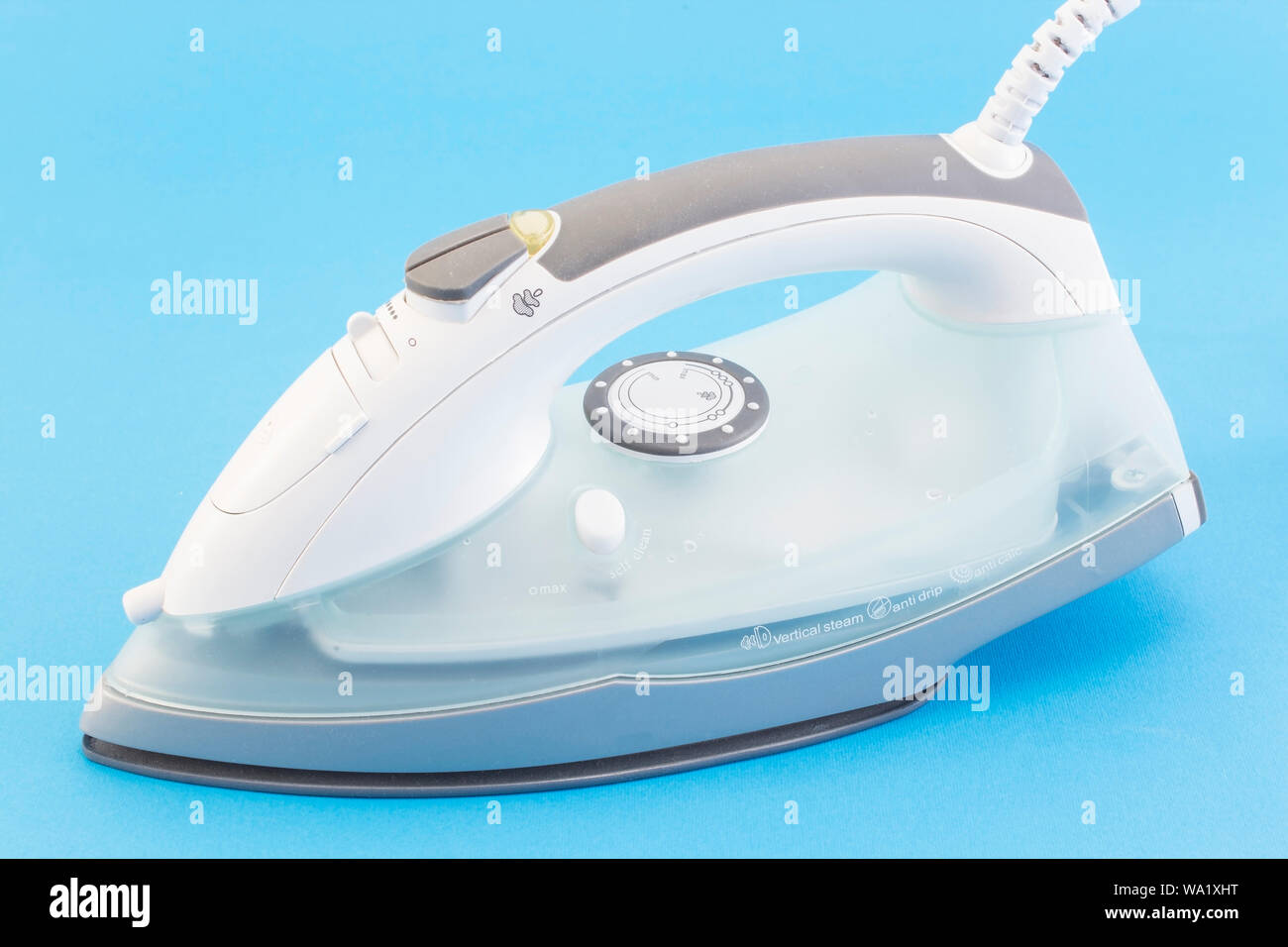 Iron Isolated on Blue Background. Stock Photo