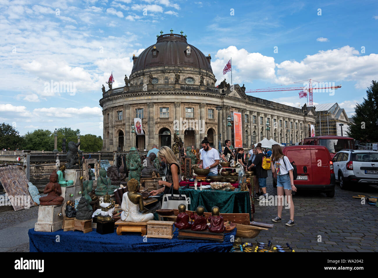 Shoppers at a booth specializing in Asian antiques at the Antique and Book Market near the Bode Museum, Berlin, Germany. Stock Photo