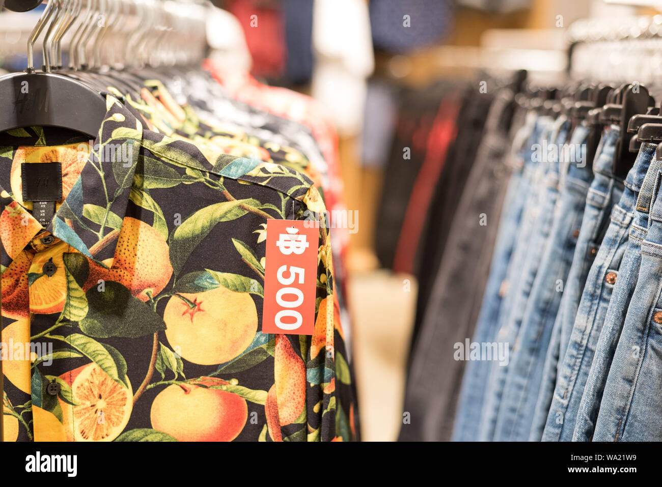 Bangkok, Thailand: a H&M shirt and a price tag 500 baht on it and rows of  clothes hanging in a H&M store at Mega Bangna shopping mall Stock Photo -  Alamy