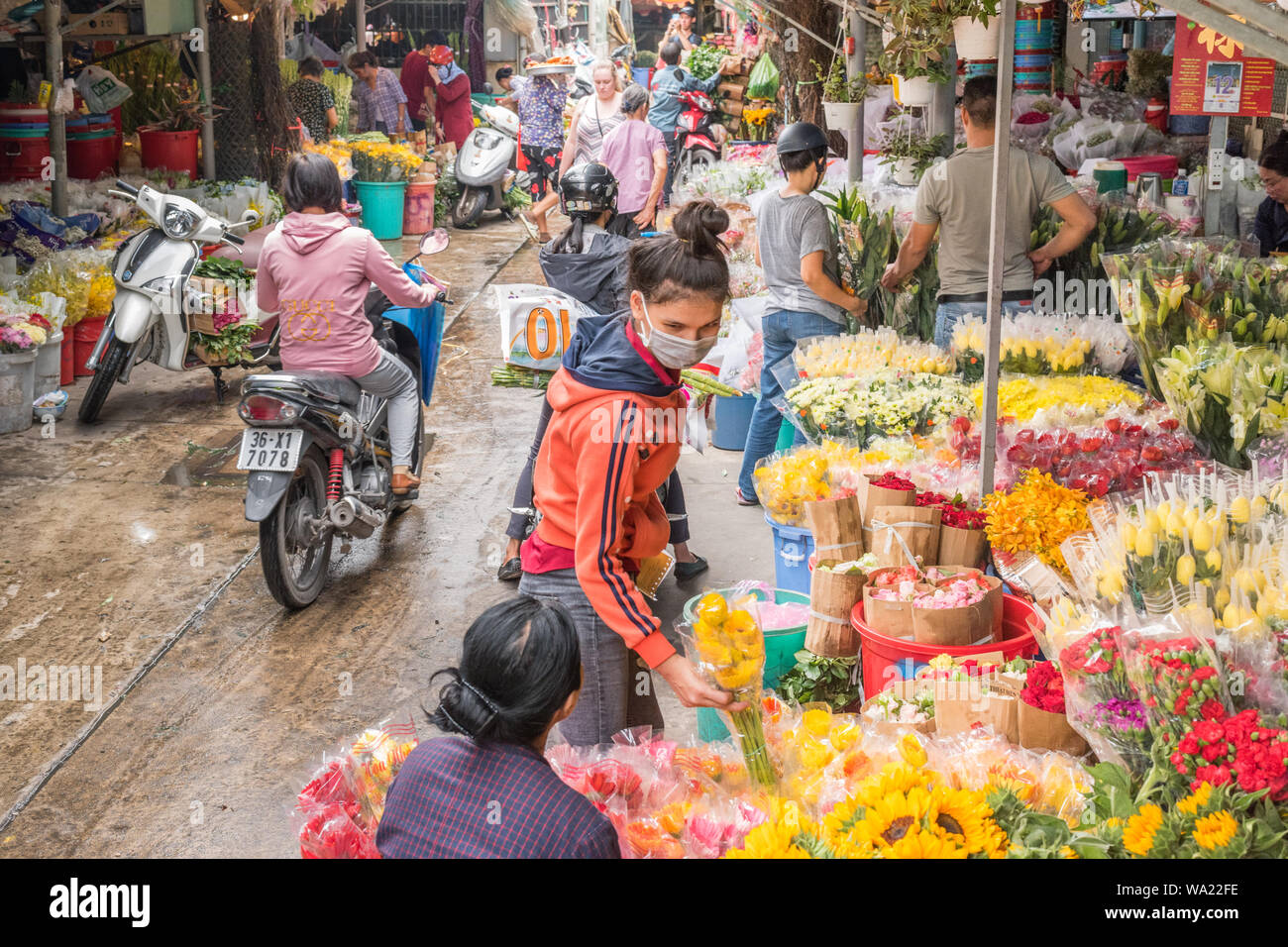 Ho Chi Minh City, Vietnam - April 12, 2019: flower vendors and buyers at Ho Thi Ky Flower Market. Stock Photo