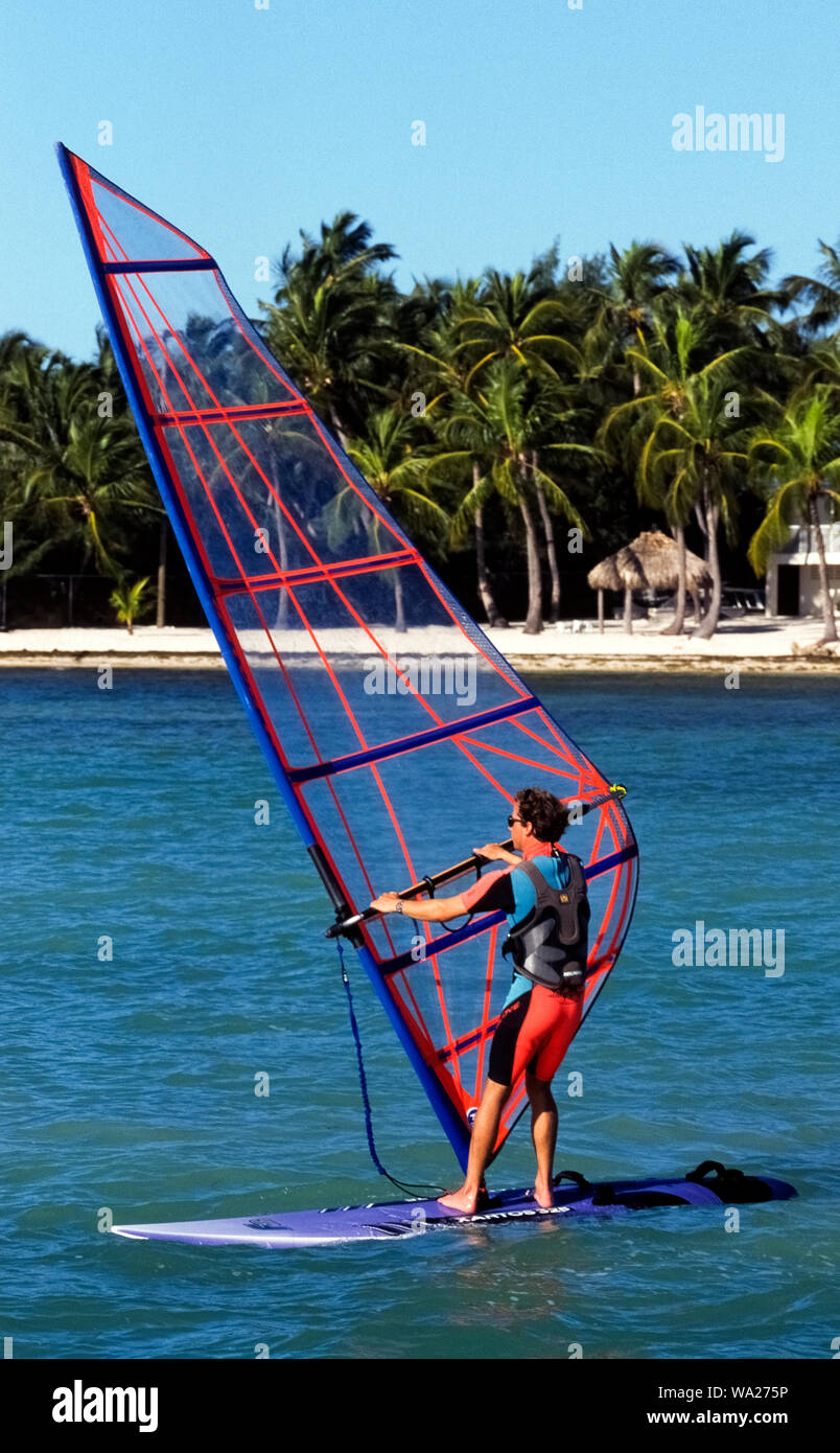 An American male windsurfer enjoys the view through his sailboard's see