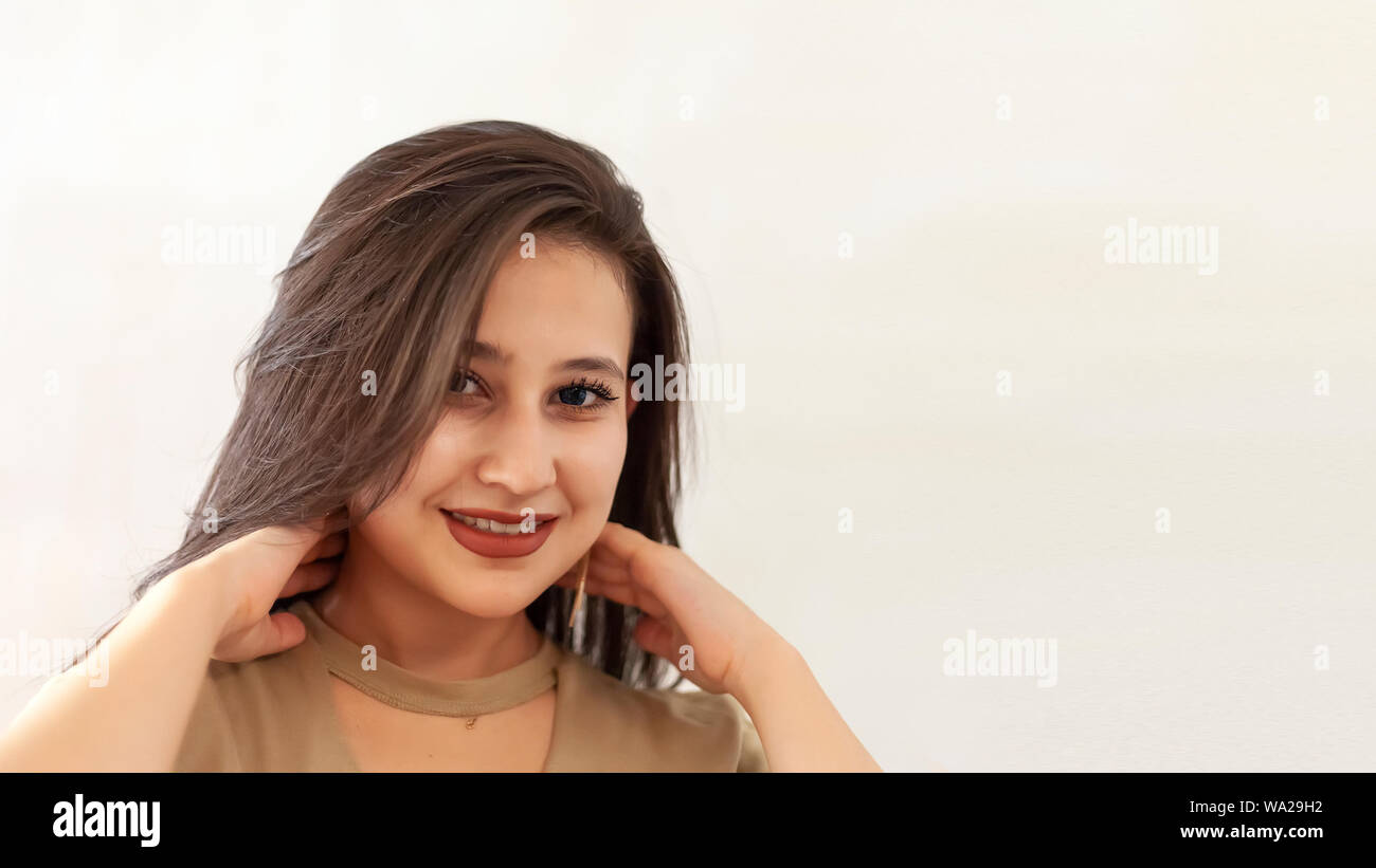 Portrait of a beautiful middle-eastern girl. Young attractive female looking into the camera and smiling. Charming, pretty posing cheerfully Stock Photo