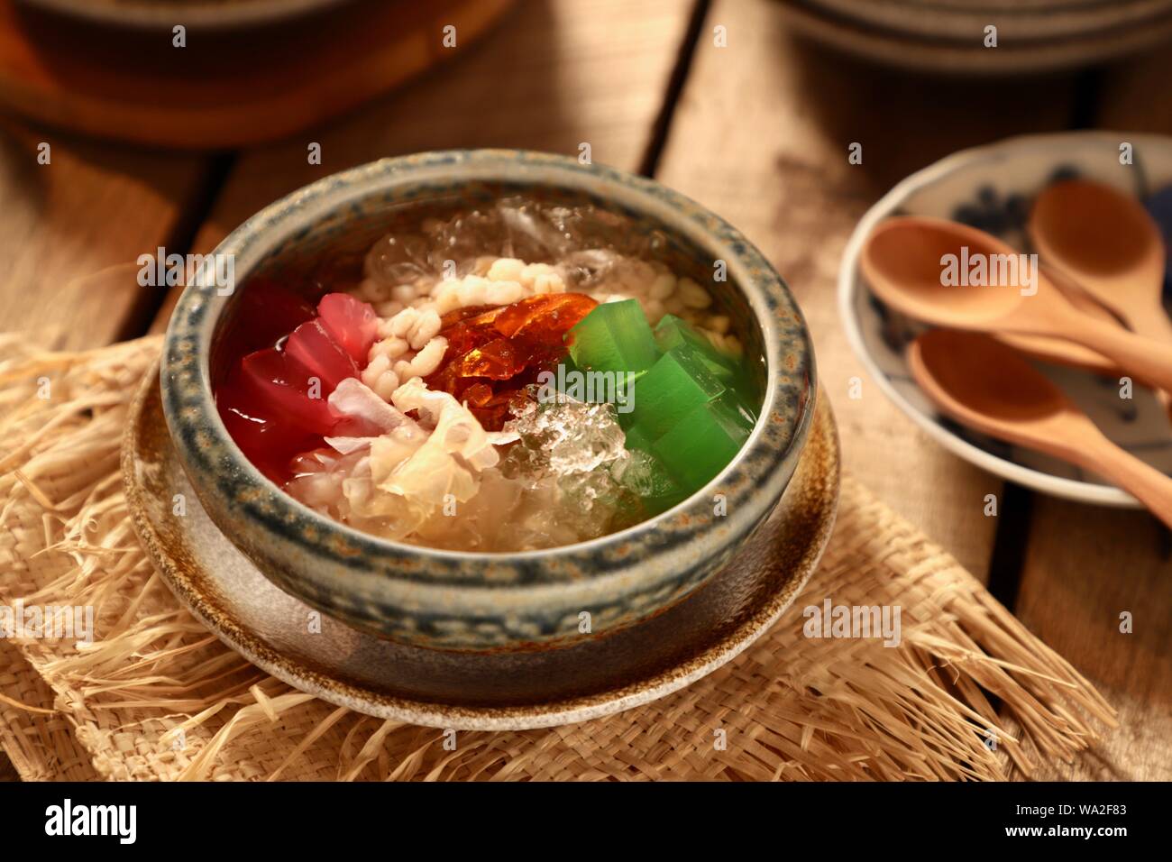 Es Sekoteng Medan. Cooling dessert cocktail of barley, palm fruit, white fungus, agar jelly, and preserved kumquat with crushed ice in sugar water. Stock Photo
