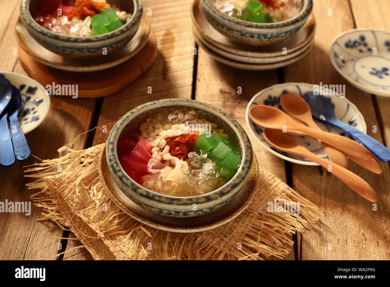 Es Sekoteng Medan. Cooling dessert cocktail of barley, palm fruit, white fungus, agar jelly, and preserved kumquat with crushed ice in sugar water. Stock Photo