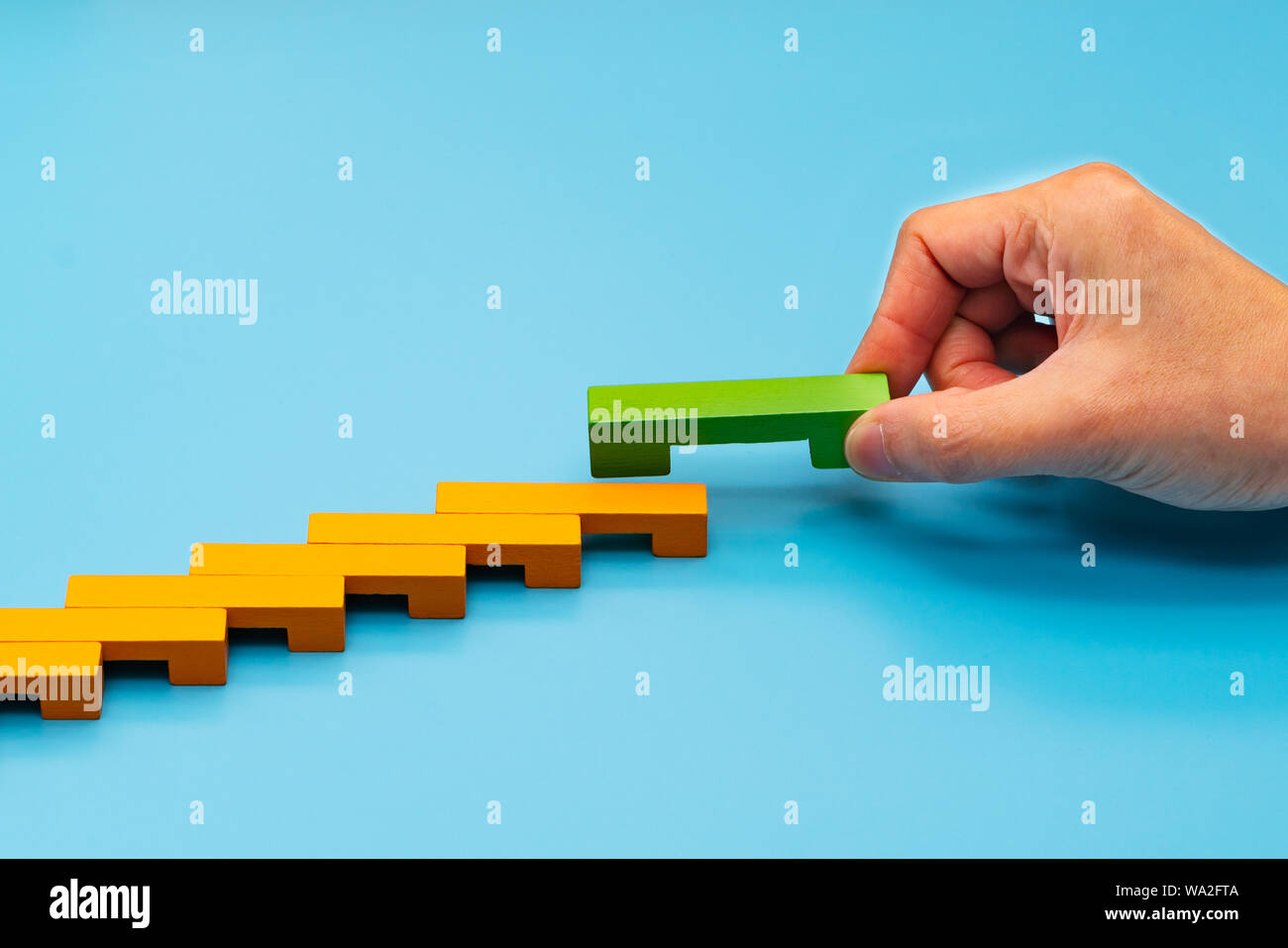 Business concept for growth success process, hand stacking wood block as step stair Stock Photo