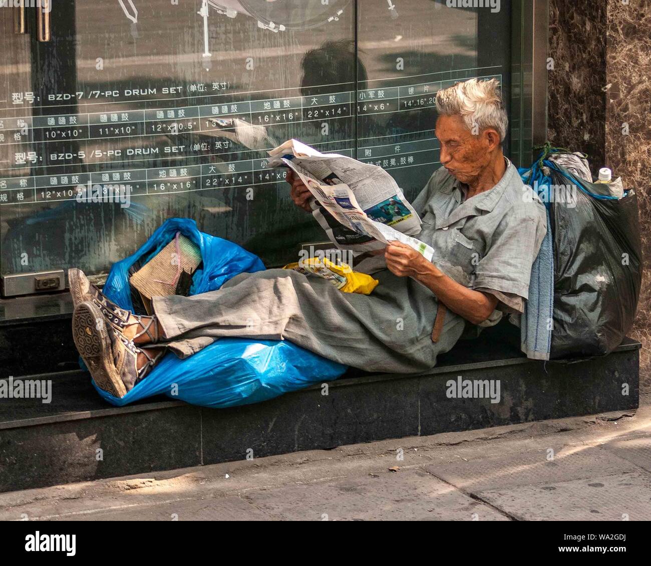 Shanghai, China. 30th Oct, 2006. A homeless man, with his