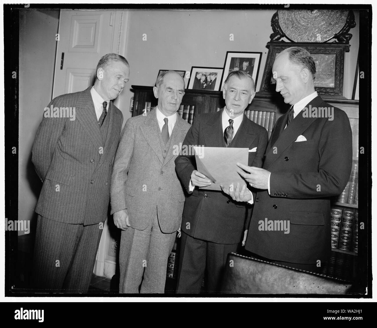 Before Senate Foreign Relations Committee. Washington, D.C., March 22. Secretary surrounded the meeting of the Senate Foreign Relations Committee in Executive session today at which Brig. Gen. George C. Marshall, Deputy Chief of Staff, Rear Ad. William D. Leahy, Chief of Naval Operations, and Undersecretary of the State Sumner Welles, were heard. Later they made a statement in support of an administration measure to aid Latin American Republics in developing their military establishments. Left to right: Marshall, Leahy, Senator Key Pittman, Chairman of Committee, and Welles, 3-22-39 Stock Photo