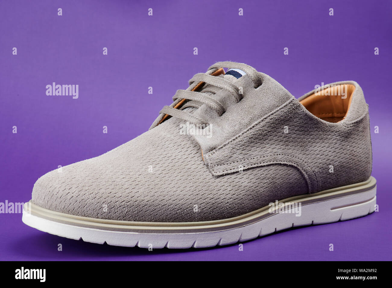 One gray modern man shoe side view isolated on purple background Stock Photo