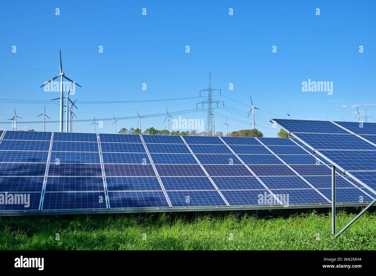 Solar panels, wind turbines and electricity pylons seen in Germany Stock Photo