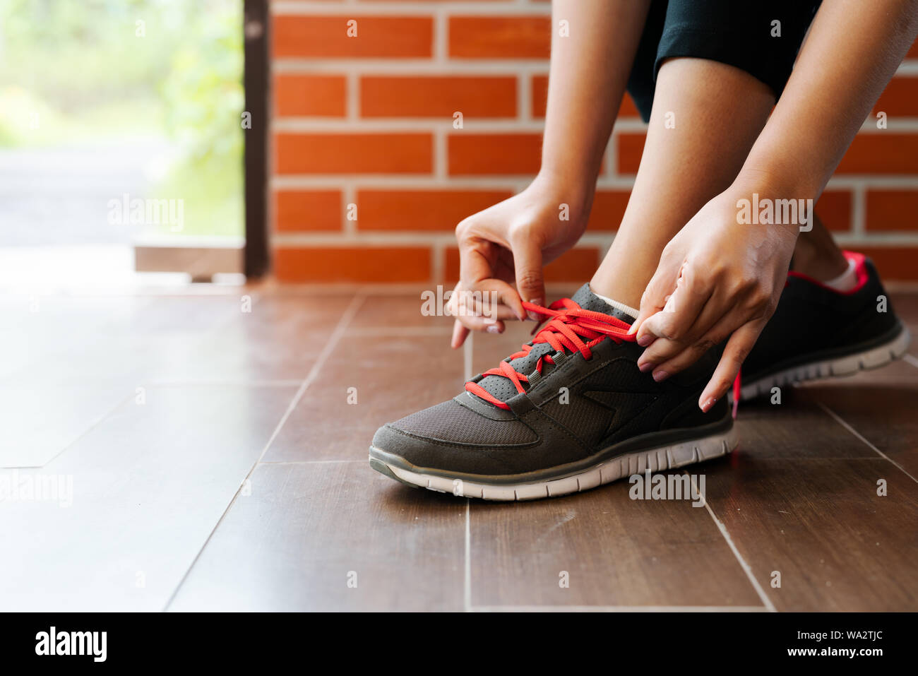 View of sport woman tying shoelace before running, outdoor activities Stock ...
