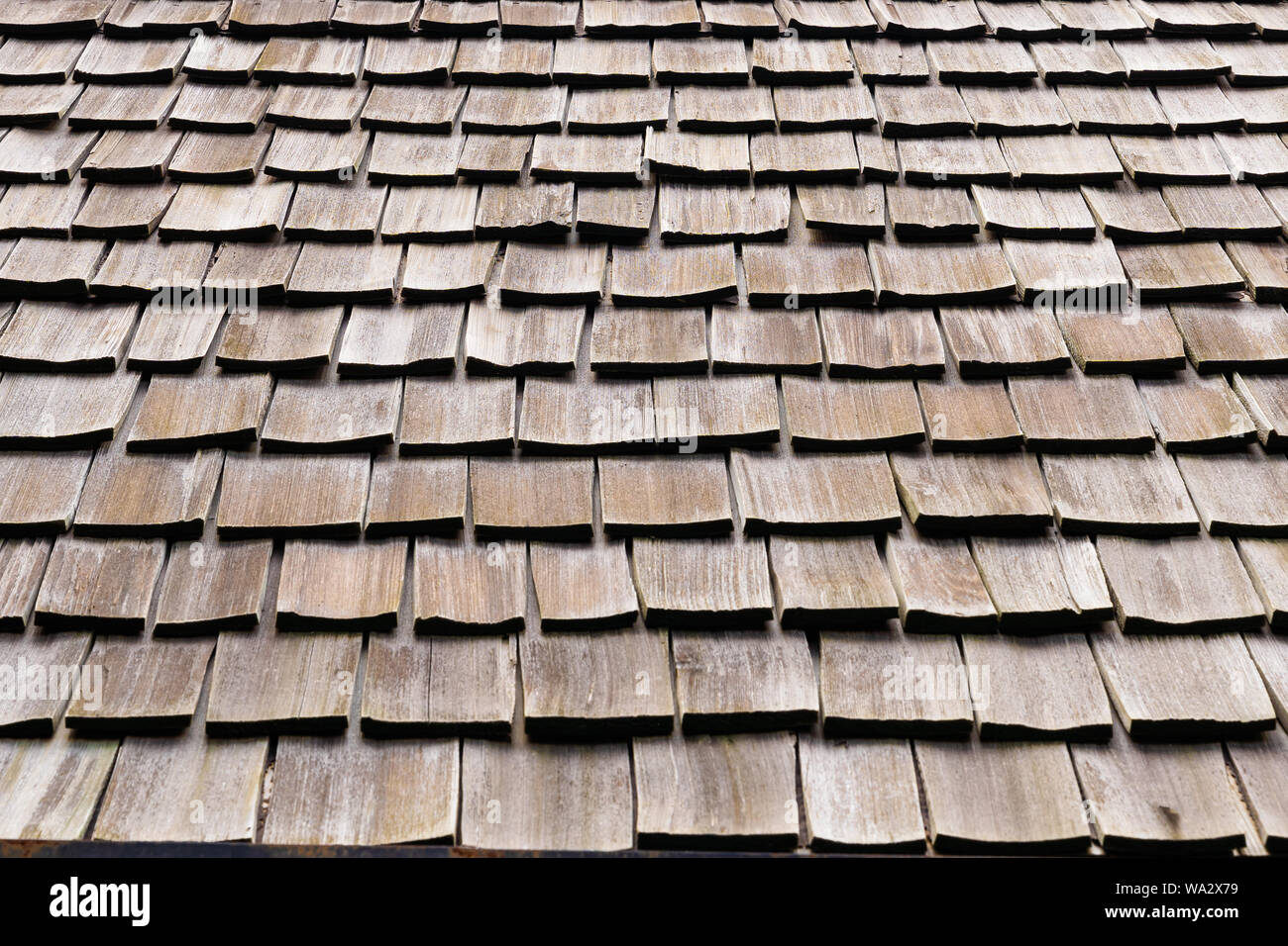 Background of Shingle aged wooden roof detail. Wood shake tile texture. Close up vintage wood roof pattern concept background. Stock Photo