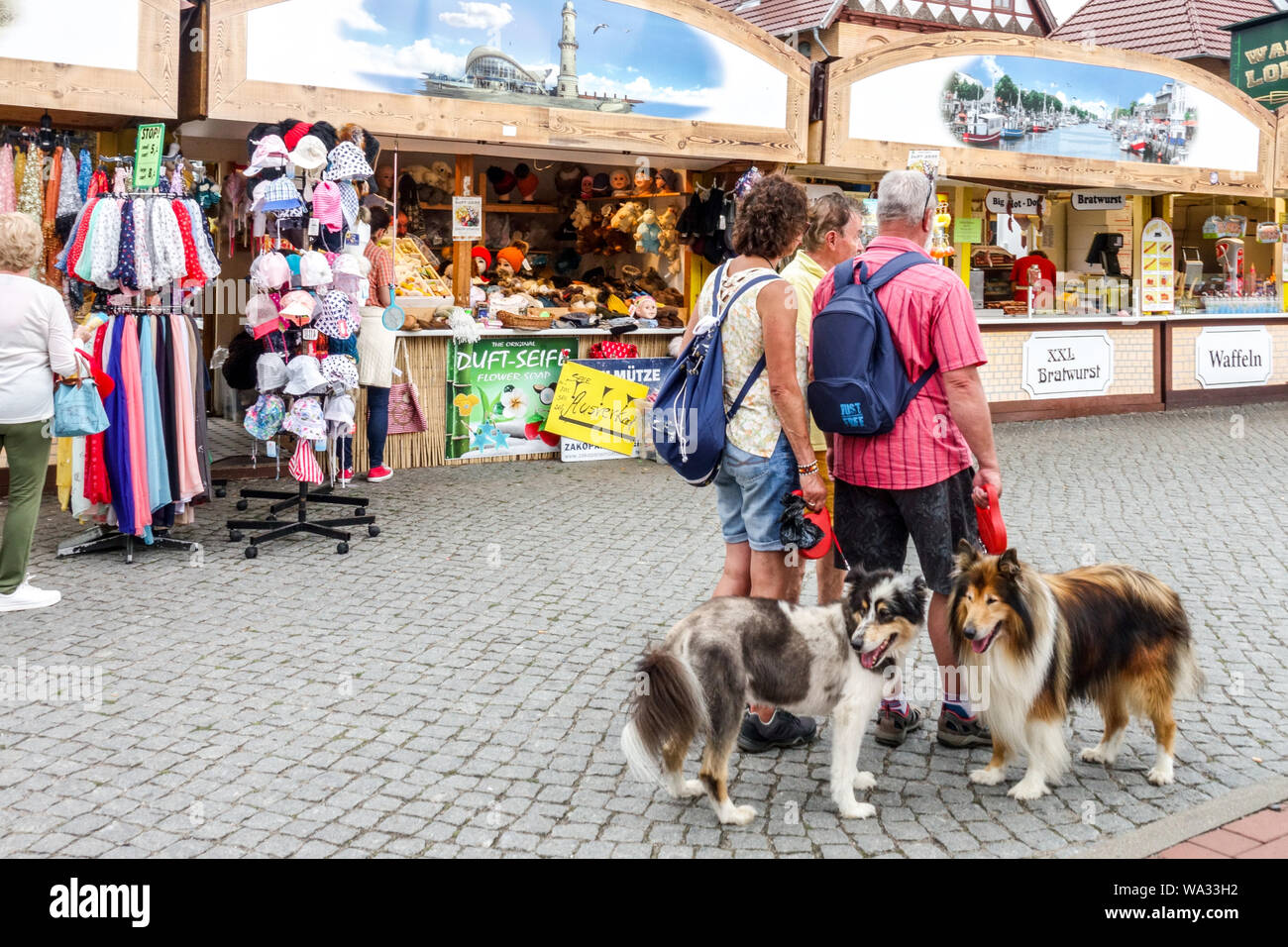 Warnemunde tourists, people walk with dogs in Old Town, stands, Rostock Germany Stock Photo