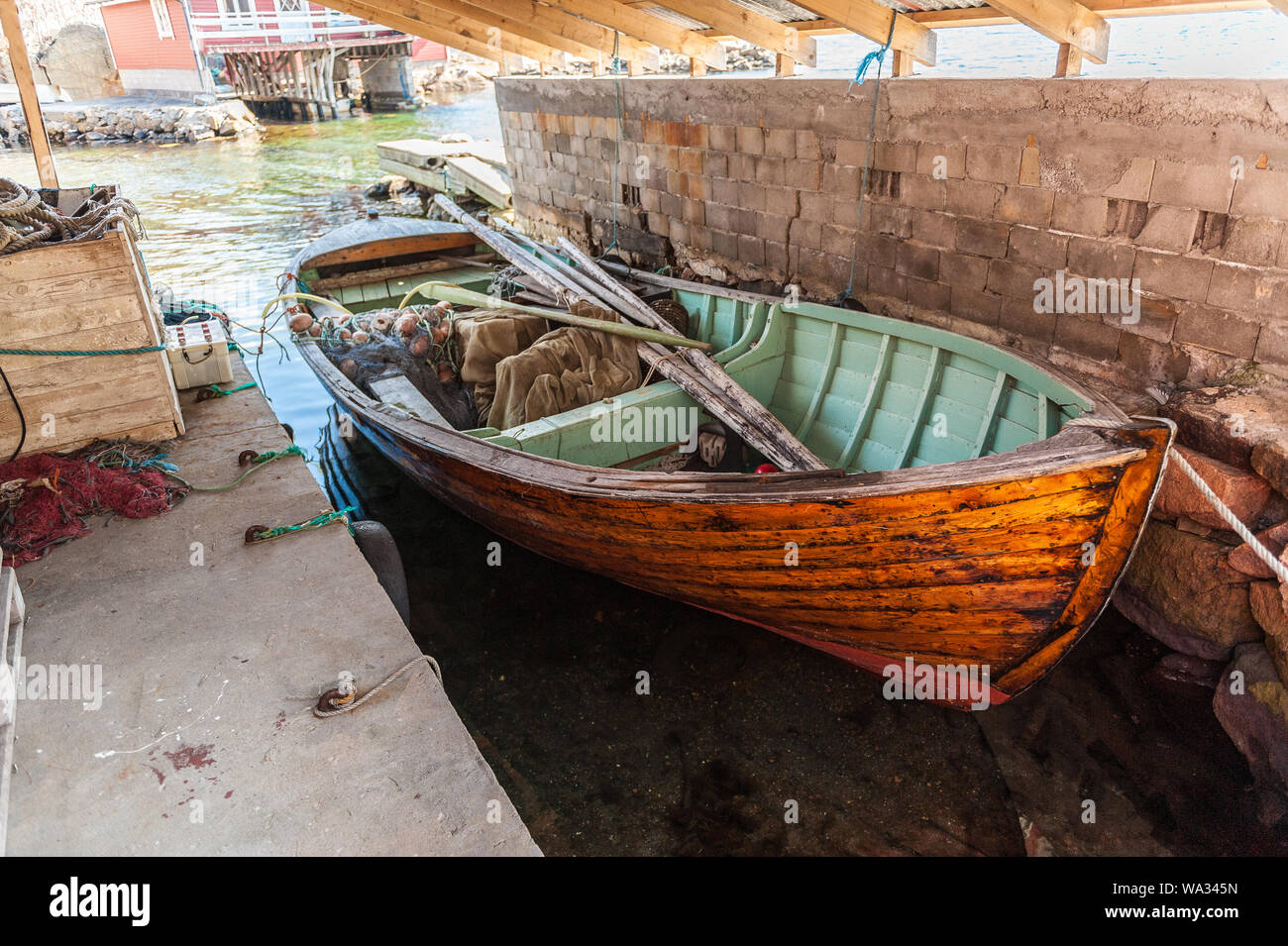 Old wooden fishing boat in a boat house Stock Photo - Alamy