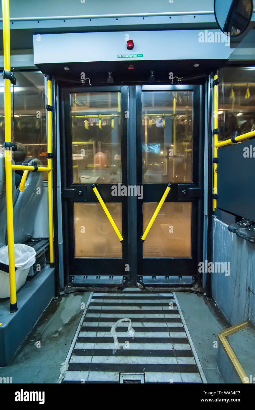 A bus door with yellow handles seen from the inside Stock Photo Alamy