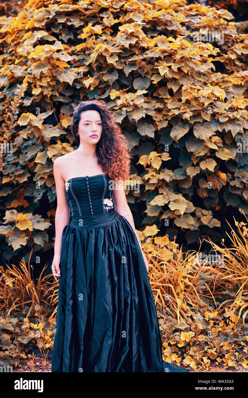 Woman wearing long black dress hi-res stock photography and images - Alamy